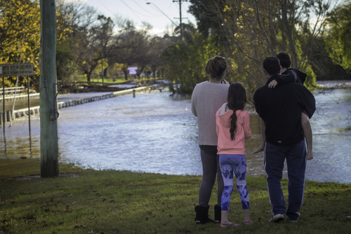family looking at flood