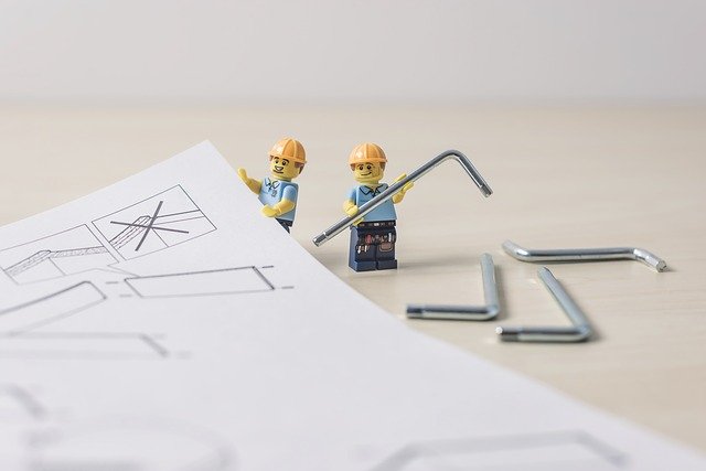 lego figures holding an allen wrench