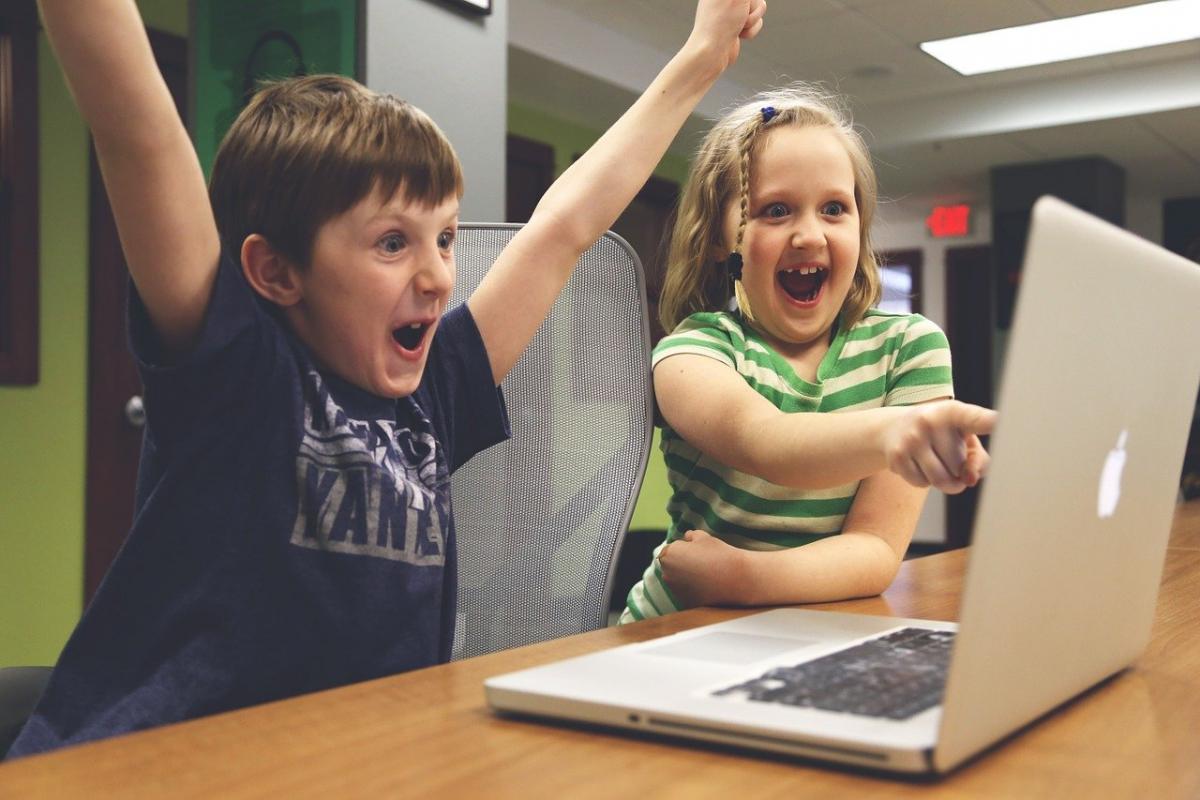 children being excited looking at a computer screen
