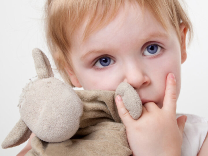 Child holding teddy bear