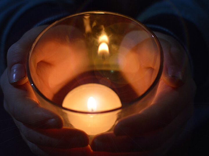 Person holding a candle.